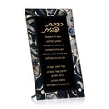Agate tabletop Birchas Habayis plaque with Hebrew text, black background, and natural stone border in cream and gray tones with metal stand.