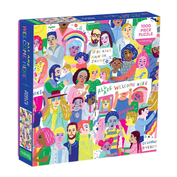 The All Are Welcome Here! 1000 Piece Family Puzzle by Sarah Walsh features diverse illustrated people holding positive signs like “BE KIND” and “WELCOME HERE.” The box reads “ALL ARE WELCOME HERE” and “CELEBRATE DIVERSITY.”.
