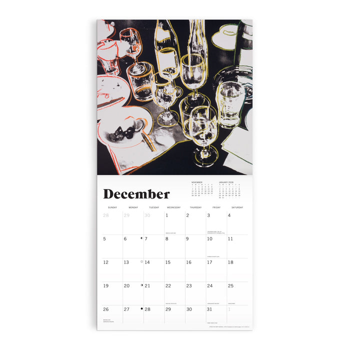 The Andy Warhol Foundation For The Visual Arts 12 x 12 Wall Calendar 2027 features December’s page with artwork of a dinner table set with glasses, bottles, plates, utensils, the month’s days below, and a yearly overview at the top.