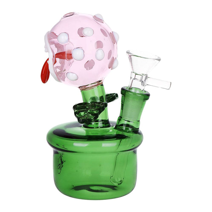 A green glass water pipe with a pink flower head, white polka dots, and a red stem, shown on a plain white background.