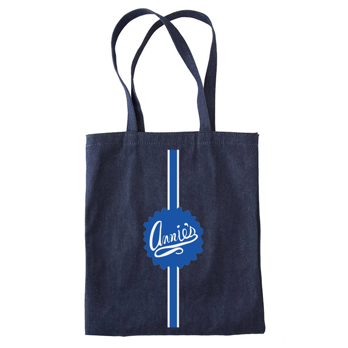 Navy denim tote bag with blue and white Annie's logo and racing stripe, front view, on a white background.