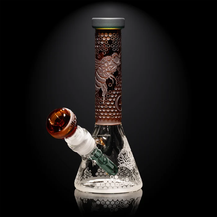 Glass smoking device with intricate designs on a black background