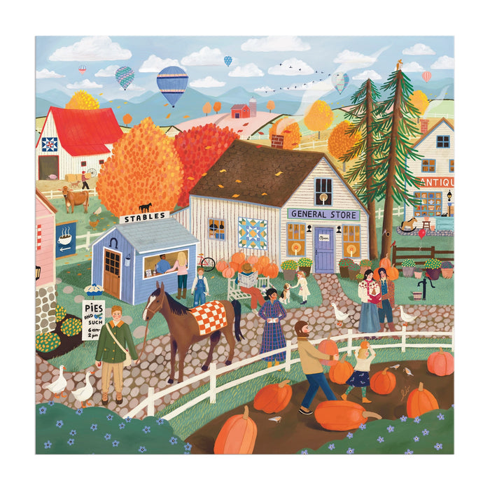 The Autumn Square 300 Piece Puzzle by Elisabeth Dorrian features a vibrant village scene with pumpkin picking, a horse at the stable, a general store, fall foliage, hot air balloons, and townsfolk enjoying seasonal fun.