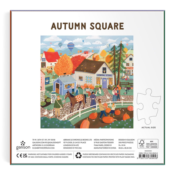 Enjoy assembling the Autumn Square 300 Piece Puzzle by Elisabeth Dorrian, featuring a vibrant autumn festival in a town square with a general store, food stalls, pumpkins, hay bales, animals, and people amid orange and yellow trees.