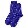A pair of royal blue crew socks with a white polka dot pattern, displayed against a plain white background.