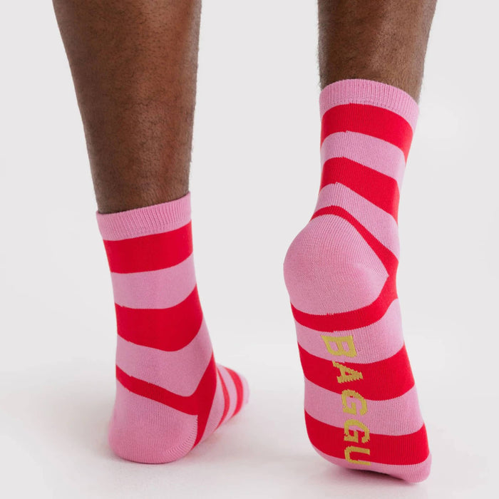 Pink and red striped socks with 'BAGGU' branding on a white background.