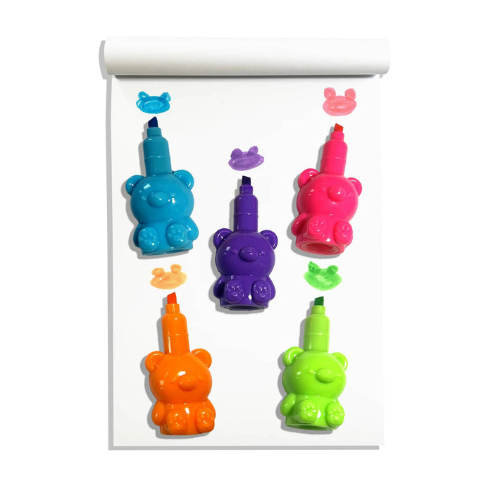 A set of colorful bear-shaped highlighter markers with chisel points in blue, purple, pink, orange, and green, arranged on a white sheet of paper with small bear doodles to show ink color.