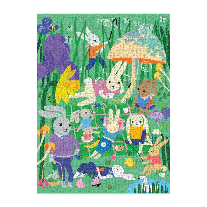 Enjoy Anne Bentley's Bunny Daydream 1000 Piece Puzzle, featuring cartoon rabbits having a lively picnic in tall grass filled with flowers and mushrooms—some eating, playing, or carrying baskets for a cheerful scene.