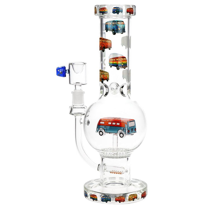 Clear glass water pipe with a bulb chamber, side arm, and base ring decorated with colorful retro bus illustrations, shown on a white background.