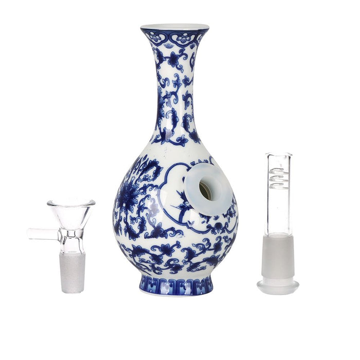 Blue and white ceramic vase with glass smoking apparatus on a white background