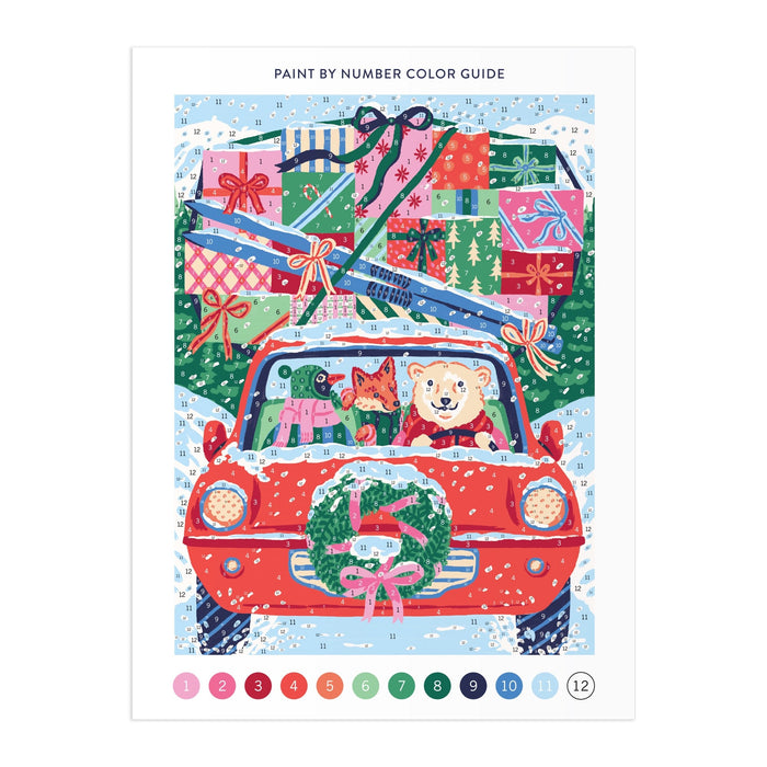 The Christmas Joyride 9 x 12" Paint by Number Kit by Emily Taylor features a red car with a dog and cat inside, adorned with a wreath and piled high with gifts on the snowy roof—a festive scene to paint and enjoy.