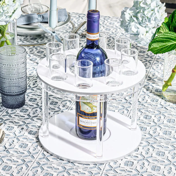 Classic round liquor set with white marble base and blue glass bottle, displayed with matching glasses on decorative surface