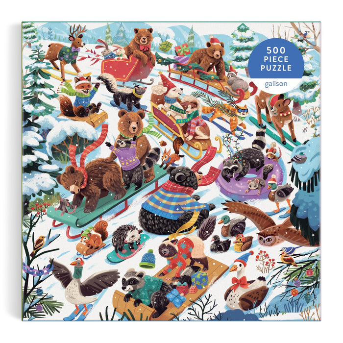 The Dashing All the Way 500 Piece Puzzle by Lucia Baertl features animals in winter sweaters sledding and playing in the snow, including bears, raccoons, foxes, birds, and otters.