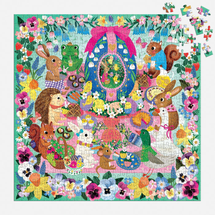 The Rebecca Jones Egg-cellent Day 500 Piece Foil Family Puzzle features adorable rabbits, hedgehogs, and birds around a decorated egg with bright flowers. Some pieces are shown in the top-right corner for festive spring fun.