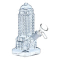 Clear glass water pipe with textured empire state design on a white background
