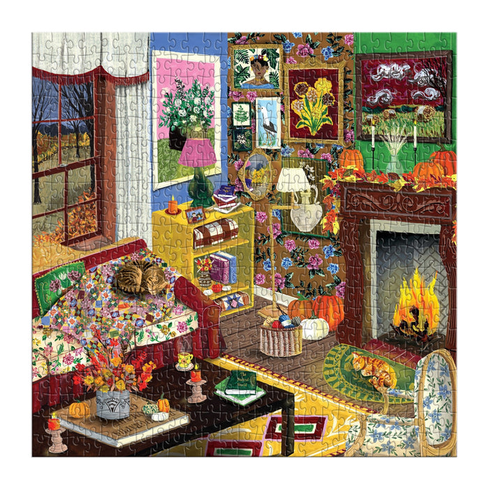 Bring autumn indoors with the Fall is in the Air 500 Piece Puzzle by Abby Jacobs. This colorful illustrated puzzle features a cozy fall living room complete with a fireplace, pumpkins, floral wallpaper, lush plants, and artful accents. A feline friend lounges on the couch while flowers brighten up the room and a window reveals a picturesque fall landscape outside—making this charming autumn puzzle the perfect rainy day activity!.