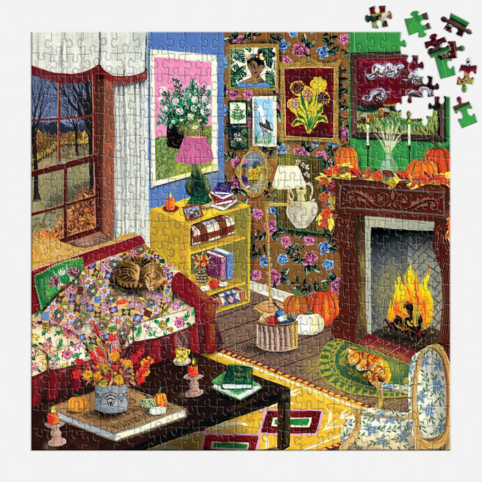 Experience cozy autumn vibes with the "Fall is in the Air 500 Piece Puzzle" by Abby Jacobs. This colorful illustrated puzzle features a warm, cluttered living room scene complete with a glowing fireplace, cheerful flowers, a cat lounging on the couch, and charming artwork on the walls. Spot pumpkins and stacks of books as you gaze out the window at a beautiful fall landscape—making it the perfect rainy day activity for puzzle lovers. Please note: some pieces may be missing in one corner.