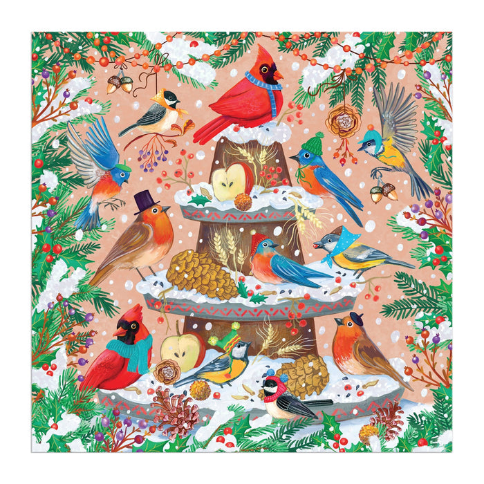 Charming avian illustrations by Olga Akbarova depict colorful, hat-wearing birds around a snowy fountain with pine branches and berries in the Festive Feathers 500 Piece Foil Puzzle.