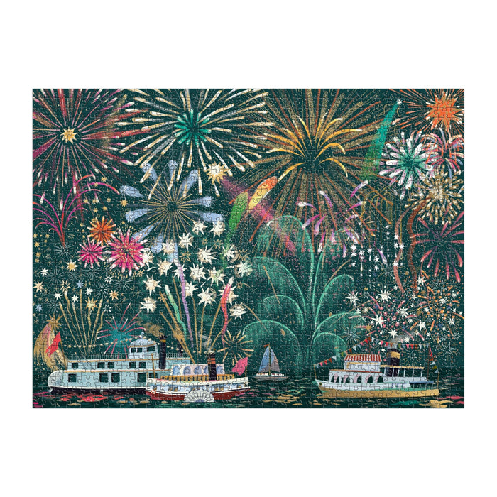 The Fireworks Jubilee 1000 Piece Foil Puzzle by Sarah Long features colorful fireworks bursting above decorated boats, with shimmering reflections on dark water for a festive celebration scene.