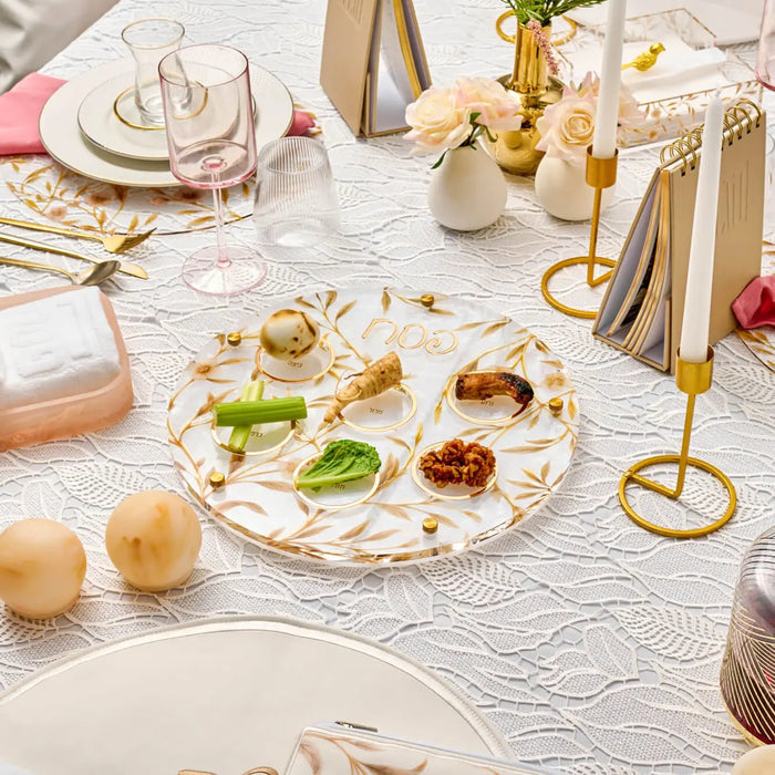 Floral Bird Seder Plate in clear lucite with botanical and bird designs, displayed on a holiday table setting with gold accents and white linens.