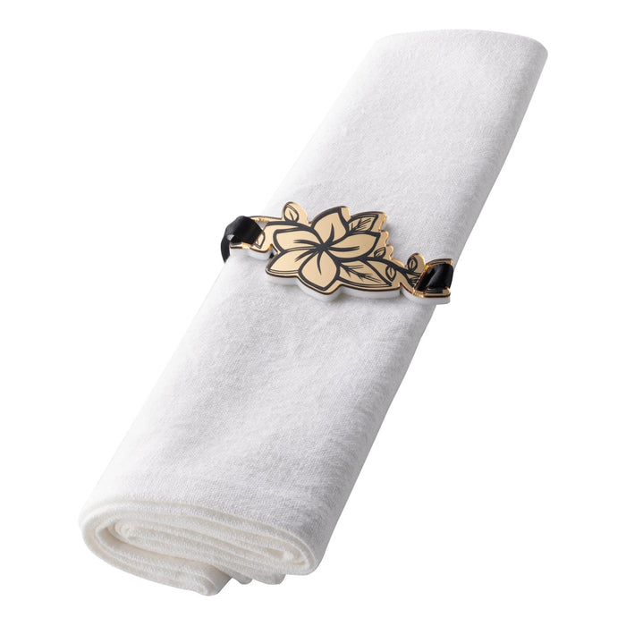 Gold floral napkin ring with black accents holding a white linen napkin, featuring detailed leaf design for table settings.