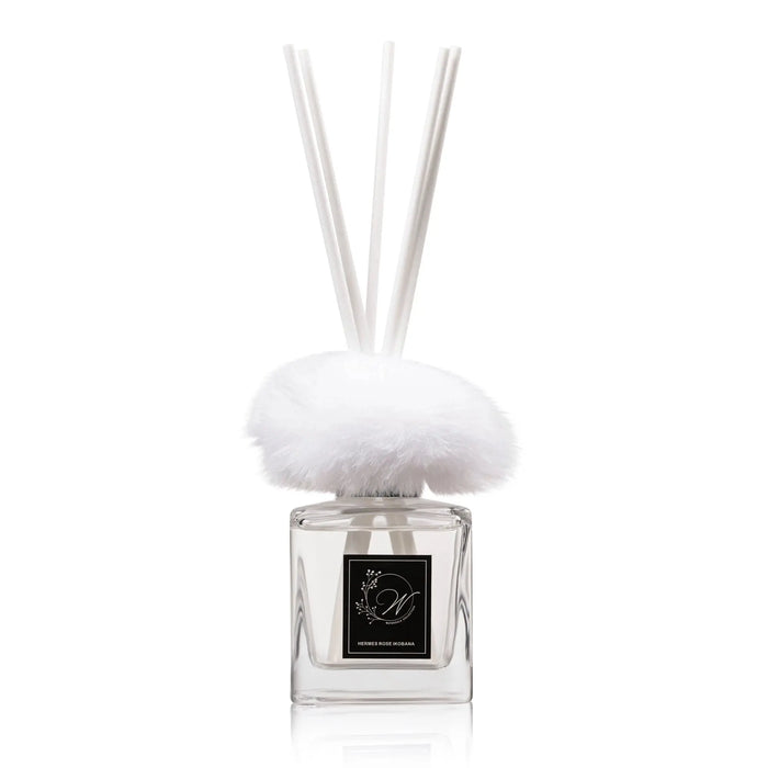 Waterdale Collection fur diffuser with white fuzzy top and clear glass bottle featuring black label and reed sticks for home fragrance.