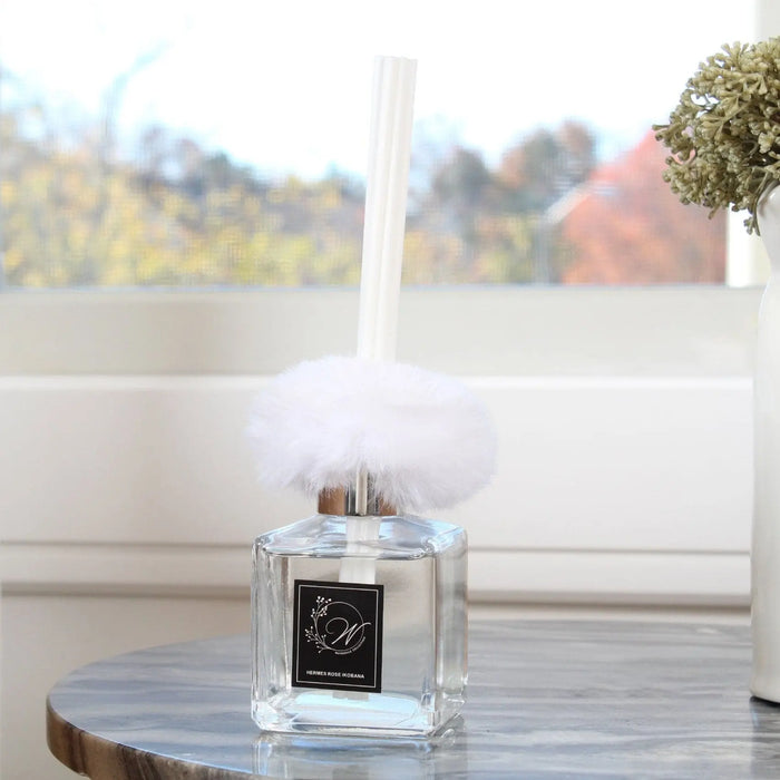 Waterdale Collection Fur Diffuser with clear glass bottle and fluffy white fur accent displayed on marble surface near window
