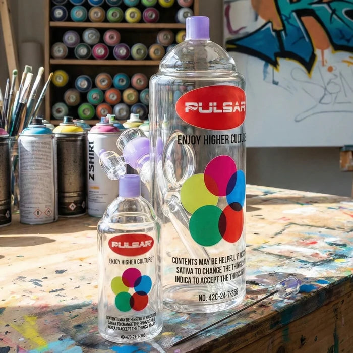 Spray can glass bong bottles on a table with art supplies and graffiti in the background