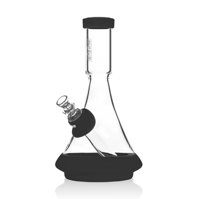 A clear glass beaker bong with a black silicone base and a green mouthpiece.