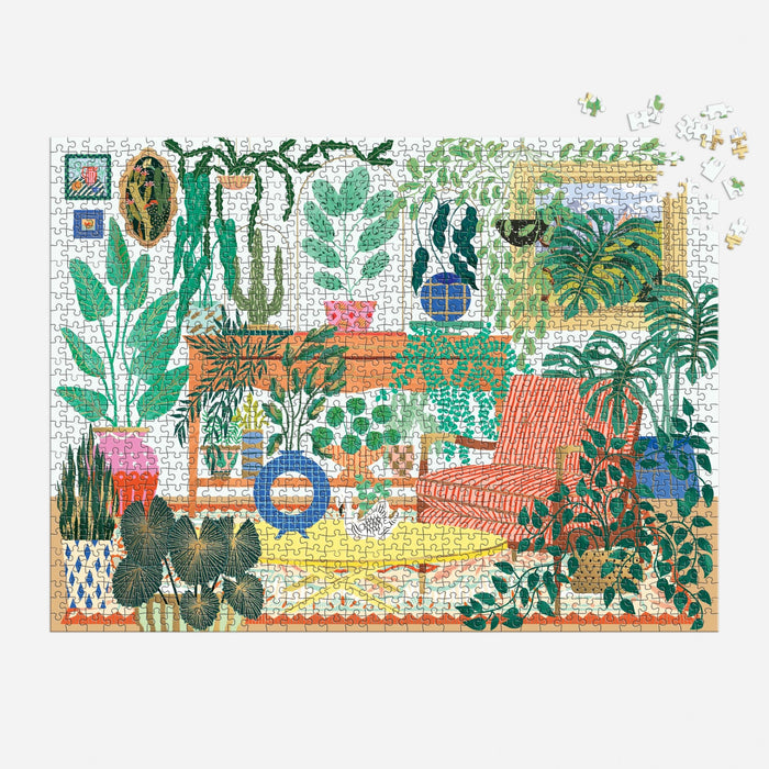 The Houseplant Haven 1000 Piece Foil Puzzle by Faye Guanipa portrays a cozy room with lush green houseplants, a red-striped chair, and wall art, with only a few pieces left to complete the upper right corner.