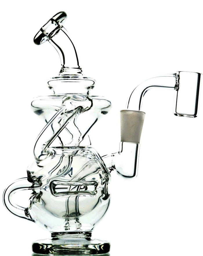 A clear glass Infinity mini rig by MJ Arsenal with intricate percolation design and a flat top quartz bucket.