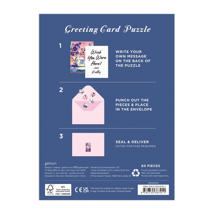 The Joy Laforme Art of the Table Greeting Card Puzzle by Joy Laforme includes a floral puzzle and envelope. Write your message on the puzzle, punch out the pieces, place them in the envelope, seal, and deliver!.