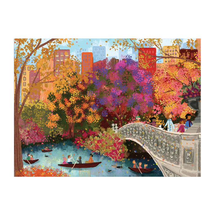 Enjoy the Joy Laforme Autumn on Bow Bridge 1000 Piece Puzzle, featuring a vibrant fall scene in Central Park with people boating near the famous Bow Bridge, colorful trees, and city buildings—a perfect autumn activity from Joy Laforme.