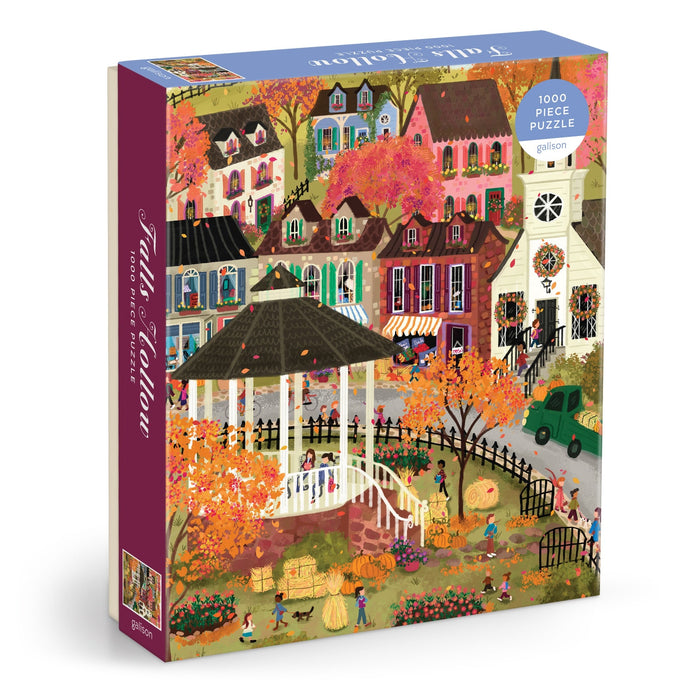 The Joy Laforme Falls Hollow 1000 Piece Puzzle by Joy Laforme features a vibrant fall village scene with colorful houses, autumn trees, a white gazebo, pumpkins, and people enjoying outdoor activities.