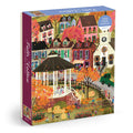 The Joy Laforme Falls Hollow 1000 Piece Puzzle by Joy Laforme features a vibrant fall village scene with colorful houses, autumn trees, a white gazebo, pumpkins, and people enjoying outdoor activities.