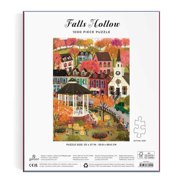 The Joy Laforme Falls Hollow 1000 Piece Puzzle by Joy Laforme features a vibrant autumn town scene with quaint houses, colorful fall trees, and a white gazebo at the center, illustrated on the puzzle box.