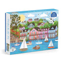The Joy Laforme Harbor by the Sea 1000 Piece Puzzle by Joy Laforme features a vibrant Nantucket-inspired seaside town, with boats, colorful houses, trees, flowers, and birds soaring above blue water.