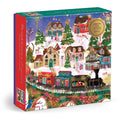 The Joy Laforme Twinkletown Express 1000 Piece Foil Puzzle features a festive winter village scene with decorated houses, snow-covered trees, reindeer, and a holiday train, all accented with colorful foil details.