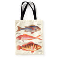 The Brass Monkey Judgy Fish Canvas Tote is a cream tote bag with black handles, showcasing three vintage-style, colorful fish illustrations, each labeled with fine black text.