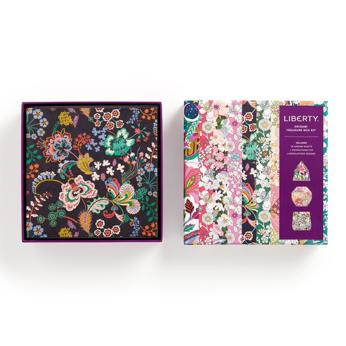 A decorative box with a Liberty Floral Origami pattern from the Liberty Origami Treasure Box Kit by Liberty of London Ltd sits beside its packaging, which showcases various Liberty patterns and the kits name on the front.