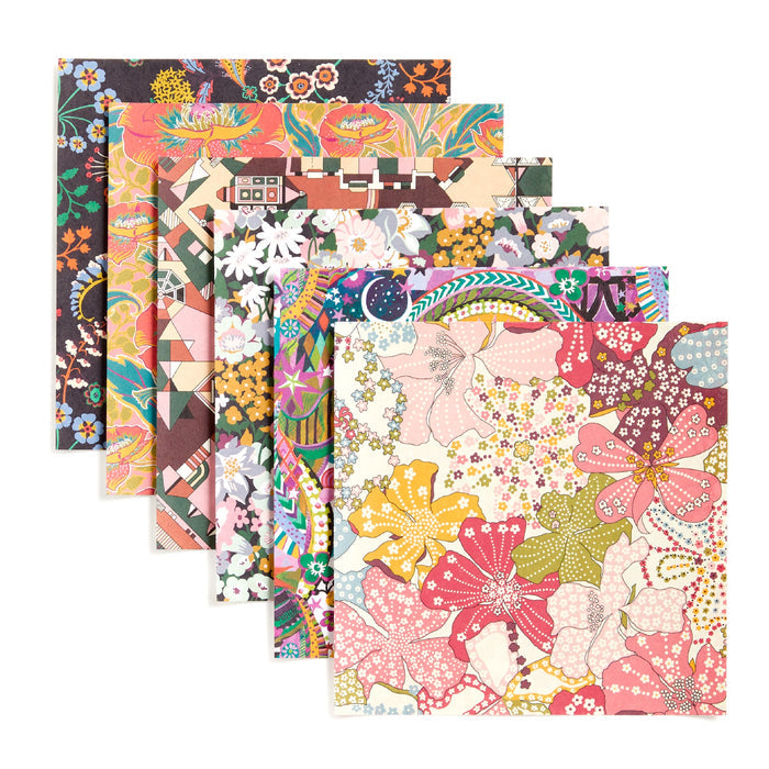 The Liberty Origami Treasure Box Kit by Liberty of London Ltd includes six square sheets with vibrant floral and geometric patterns in pink, orange, yellow, green, and blue—perfect bold designs for any origami kit.