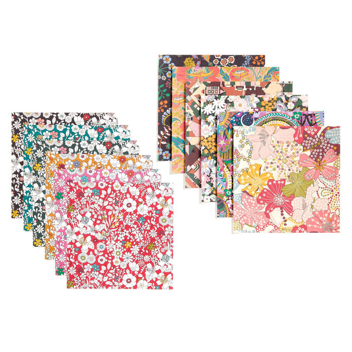 Twelve square sheets from the Liberty Origami Treasure Box Kit by Liberty of London Ltd are displayed in two overlapping stacks, each featuring colorful and varied floral patterns in different colors, densities, and styles.