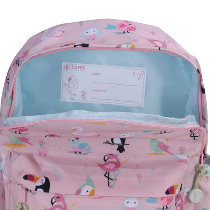 Pink backpack with a colorful bird pattern, shown open to reveal a light blue interior lining and a white name label. The brand name 'LUND BACKPACK' is visible on the label.