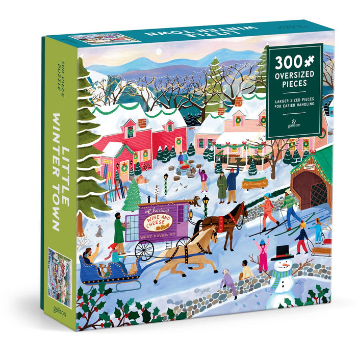 The Elisabeth Dorrian Little Winter Town 300 Piece Puzzle features a vibrant winter village with people ice skating, riding a horse-drawn sleigh, and enjoying snowy cottages in the background. Oversized pieces for easy handling.