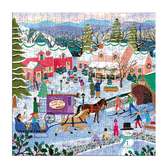 The Little Winter Town 300 Piece Puzzle by Elisabeth Dorrian features a vibrant village scene with people ice skating, building snowmen, riding horse-drawn sleighs, and shopping among festively decorated, snow-covered homes.