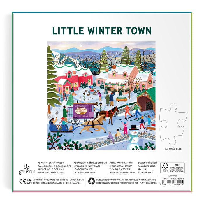 A colorful illustration of a snowy town with ice skaters, a horse-drawn sleigh, festive décor, and snowy houses appears on the back of the Elisabeth Dorrian Little Winter Town 300 Piece Puzzle box.