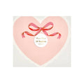 Heart-shaped pink napkins with a red ribbon, in packaging, on a white background.