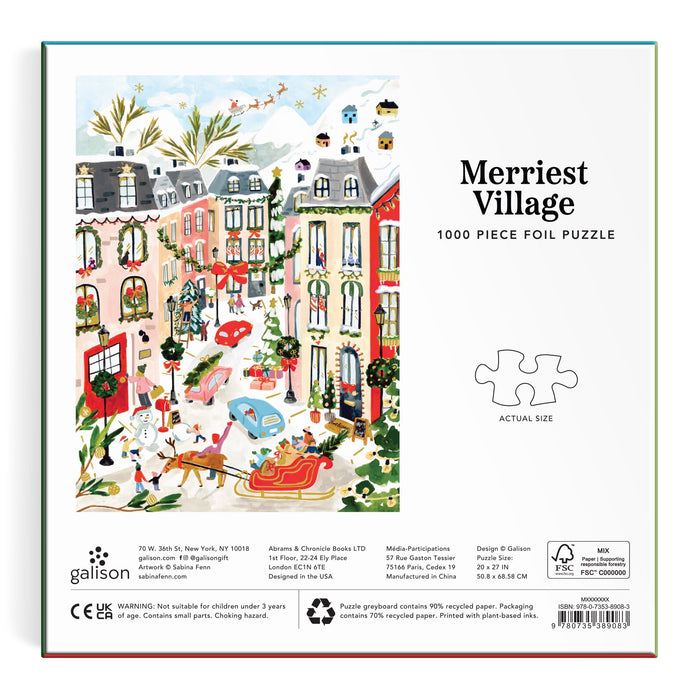 The image shows the Sabina Fenn Merriest Village 1000 Piece Foil Puzzle, featuring a festive village scene with decorated houses, people, dogs, snow, and holiday decorations on the box.
