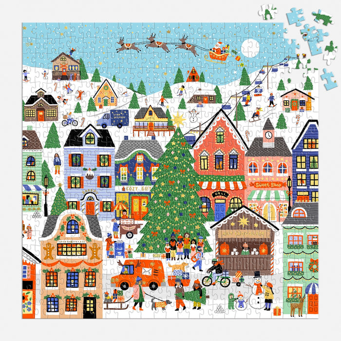 Enjoy assembling the Holly Maguire Merryville 500 Piece Foil Puzzle, featuring a vibrant winter village with snow, decorated houses, a Christmas tree, skaters, shoppers, and Santa’s sleigh. Just a few pieces remain at the top right!.