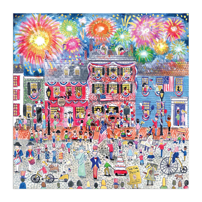 The Michael Storrings Celebrate The USA 500 Piece Foil Puzzle by Michael Storrings features a festive Fourth of July street scene with waving flags, fireworks, decorated historic buildings, and a lively parade and celebration.